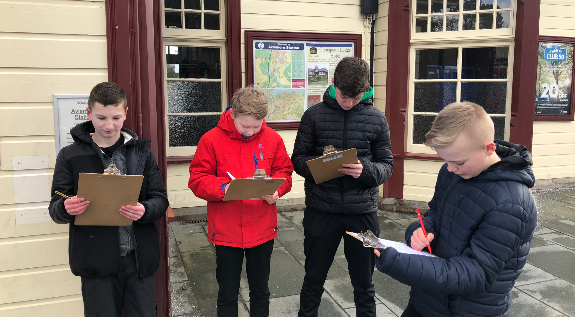 Pupils from Kingussie School write down ideas from An Camas Mòr