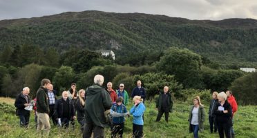 People interested in An Camas Mòr on a tour of the site